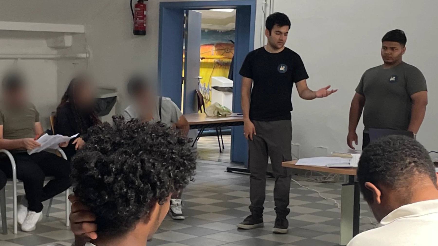 Abobakar Sediq Miakhel teaching a group of refugees for AILEM