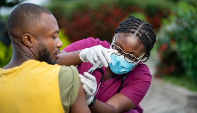 people giving/receiving vaccine