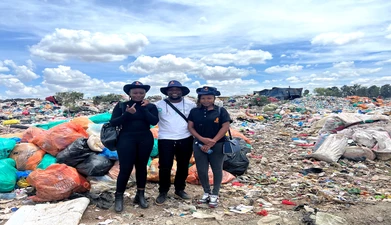 people pausing in front of bin bags