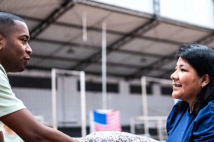 People exchanging blankets